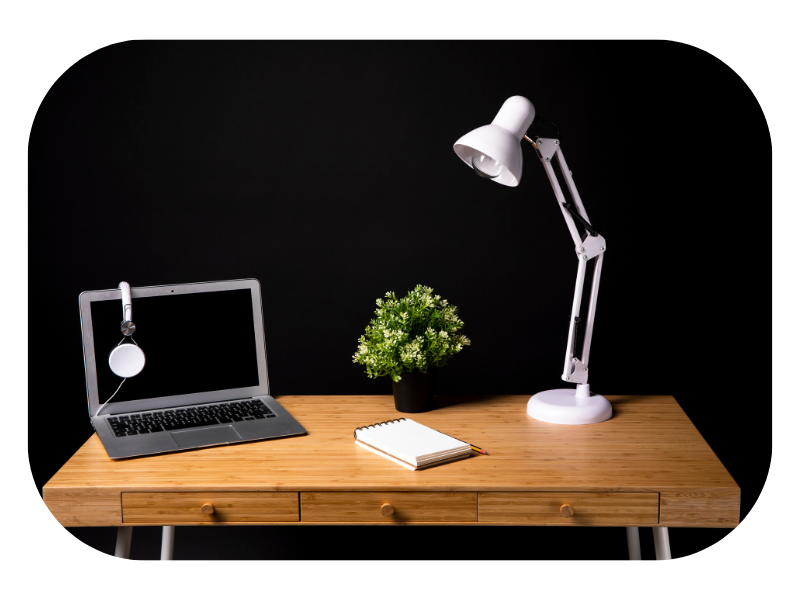 desk lamp photography setup with laptop and notepad